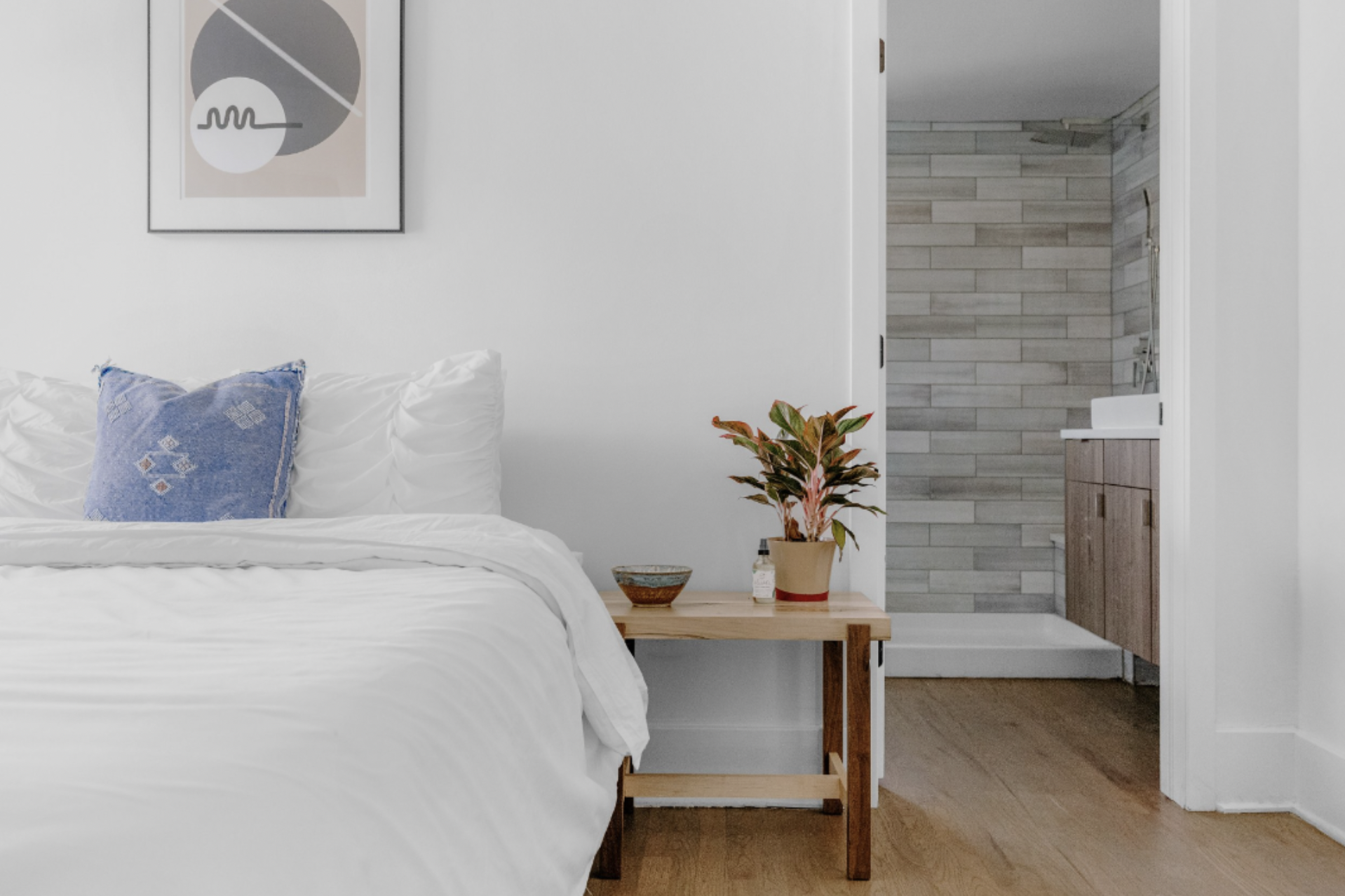 minimal bedroom featuring bed with white linens